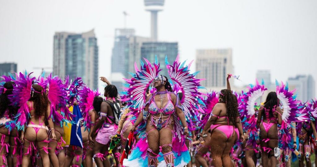 Costumed dancers and mas bands add sizzle to a sweltering day at the Toronto Caribbean Carnival Grand Parade