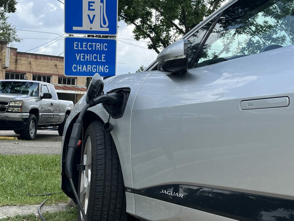 Electric car plugged into charging station