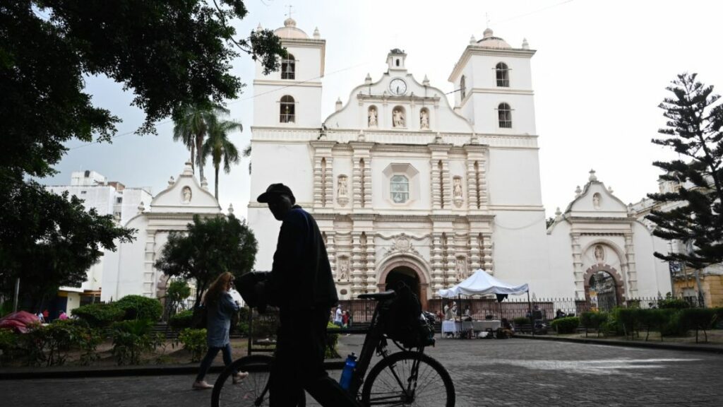 A man walks by on his bicycle in front of the San Miguel Arcangel Cathedral in the historic center of Tegucigalpa.