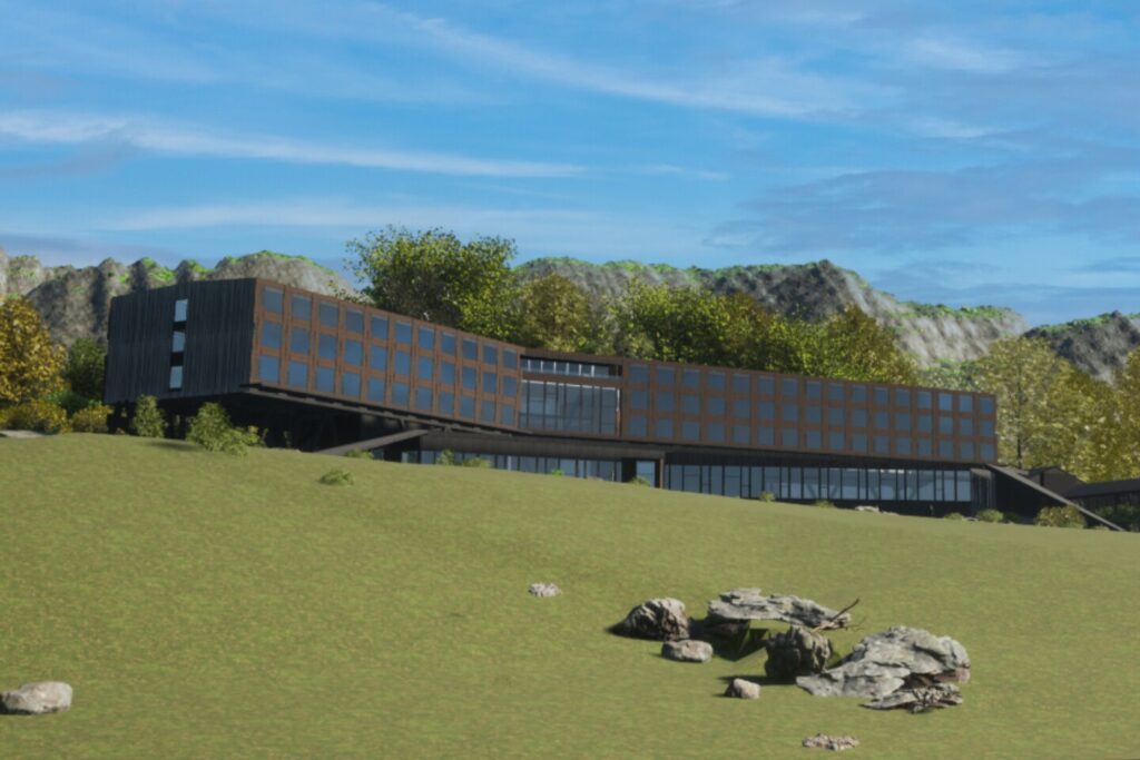 A rendering of the forthcoming hotel in Puerto Williams, Chile, currently being built by Silversea, featuring a sleek, modern, four-story box-like building, with mountains in the background