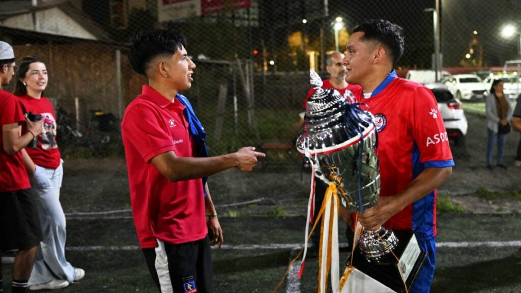 Hector Sanchez (R) and Edison Flores, who received organ transplants, pose with the Transplant Football World Cup trophy during a training session with of the Chilean transplanted football team in Santiago