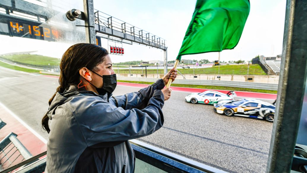 Julie Obreiter of the Cayman Islands Department of Tourism Waves the Green Flag on Porsche Carrera Cup North America Presented by the Cayman Isands - COTA - Race 1, 2021, PCNA