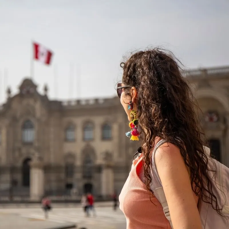 Young Female Tourist Admiring A Colonial Building In Peru, Lima, South America
