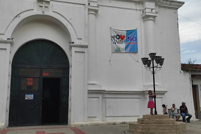 A banner hanging from the Catholic church on the Asunción Mita town square reads, 