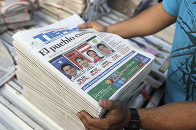 Newspapers covering the election of Juan Orlando Hernández are stacked up. (Reuters/Jorge Cabrera)