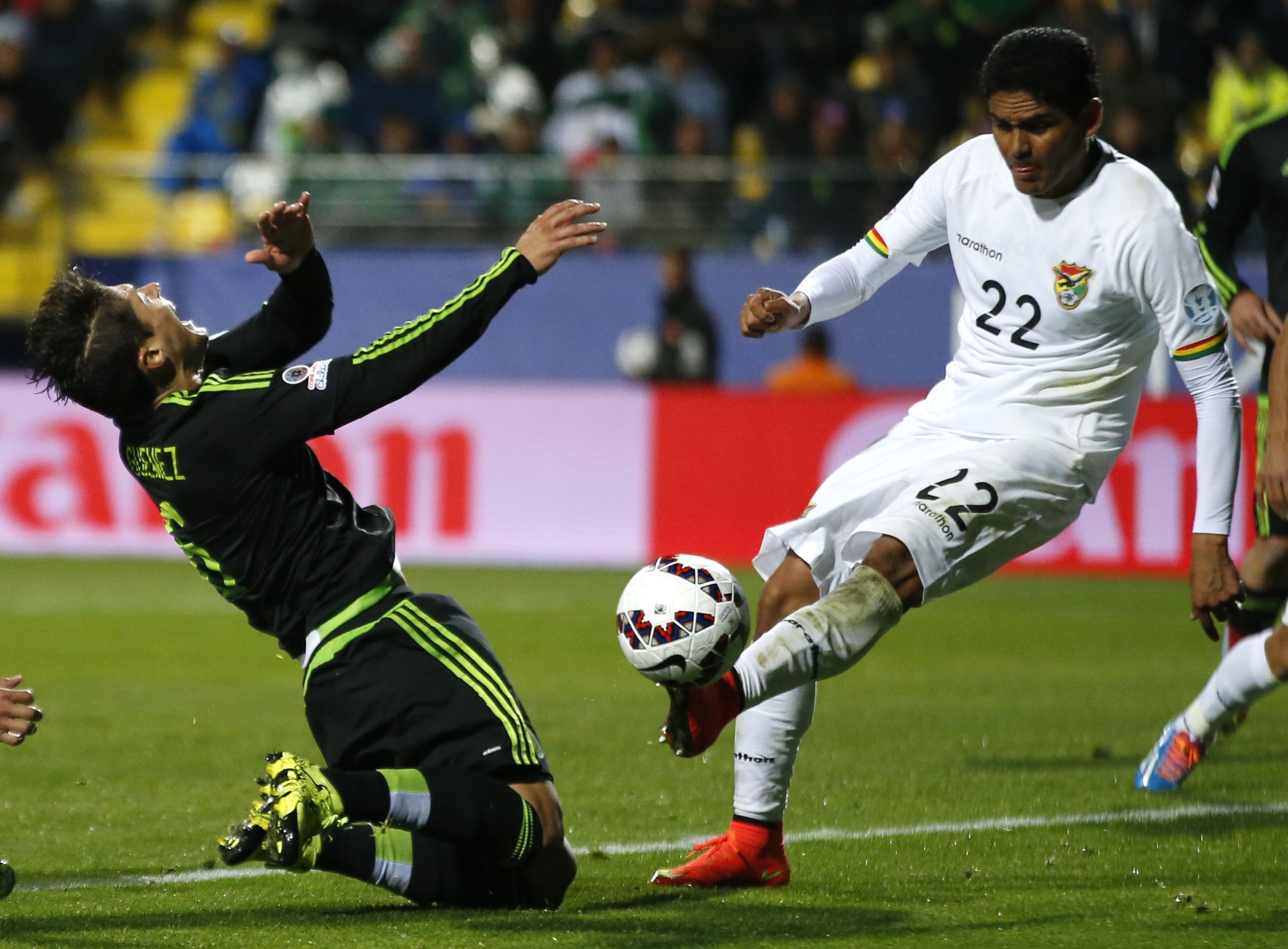Mexico's Javier Guemez falls as Bolivia's Edward Zenteno controls the ball