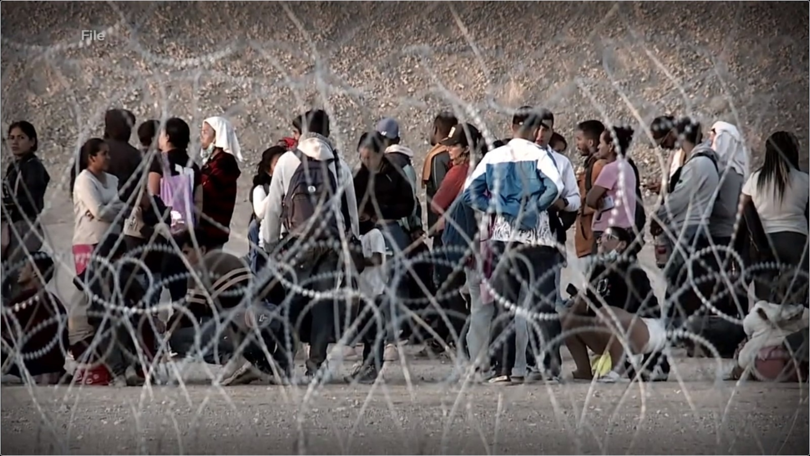 PHOTO: Thousands of South American migrants cross a border.