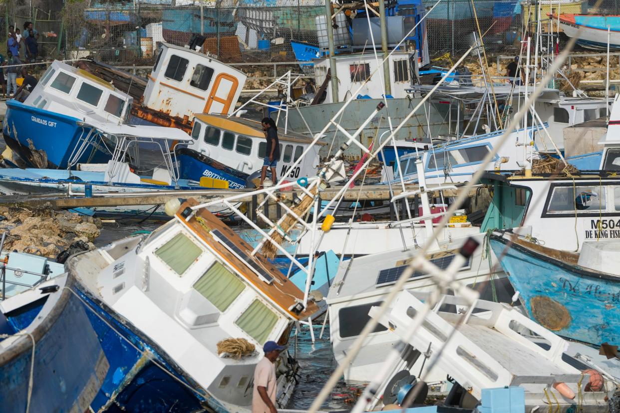 A man looks at damaged fishing boats after Hurricane Beryl blew through Barbados (Copyright 2024 The Associated Press. All rights reserved)