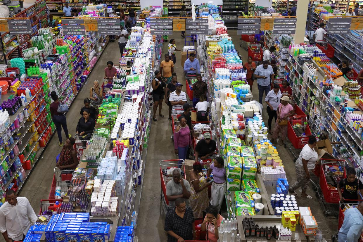 People queue for groceries in Kingston, Jamaica ahead of Hurricane Beryl (REUTERS)