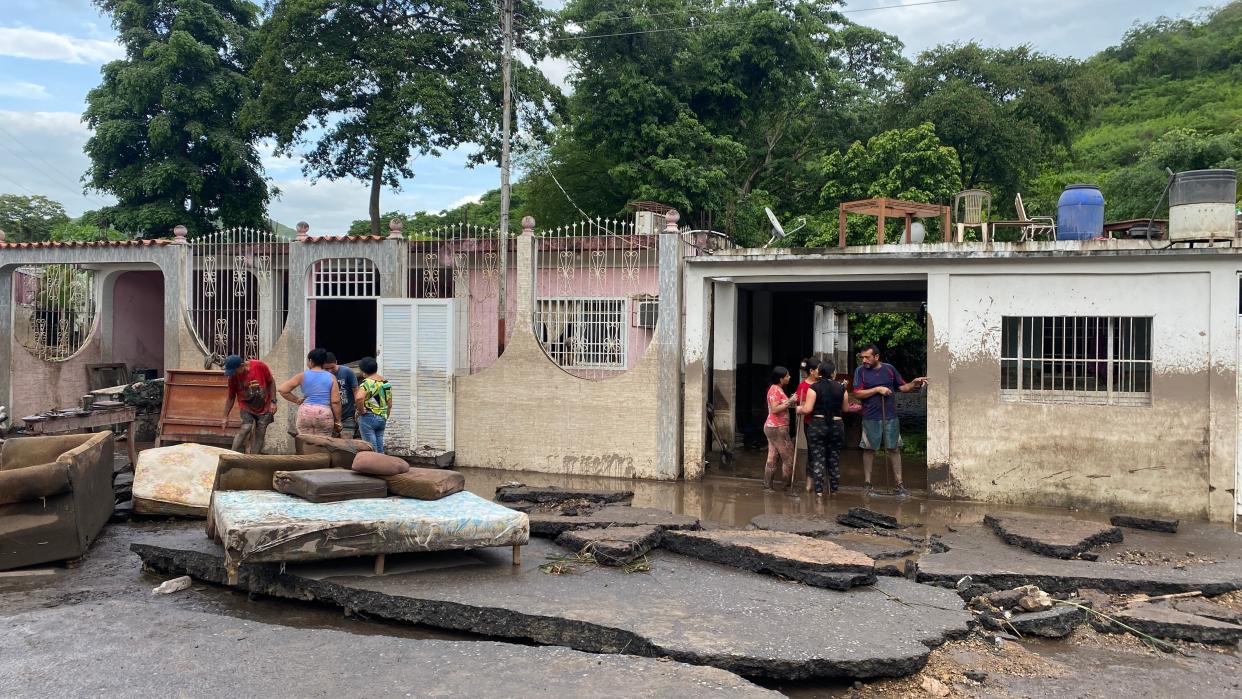 Residents try to recover their belongings from their flooded houses after a river swelled due to heavy rains following the passage of Hurricane Beryl on the road from Cumana to Cumanacoa, Sucre State, Venezuela (AFP via Getty Images)