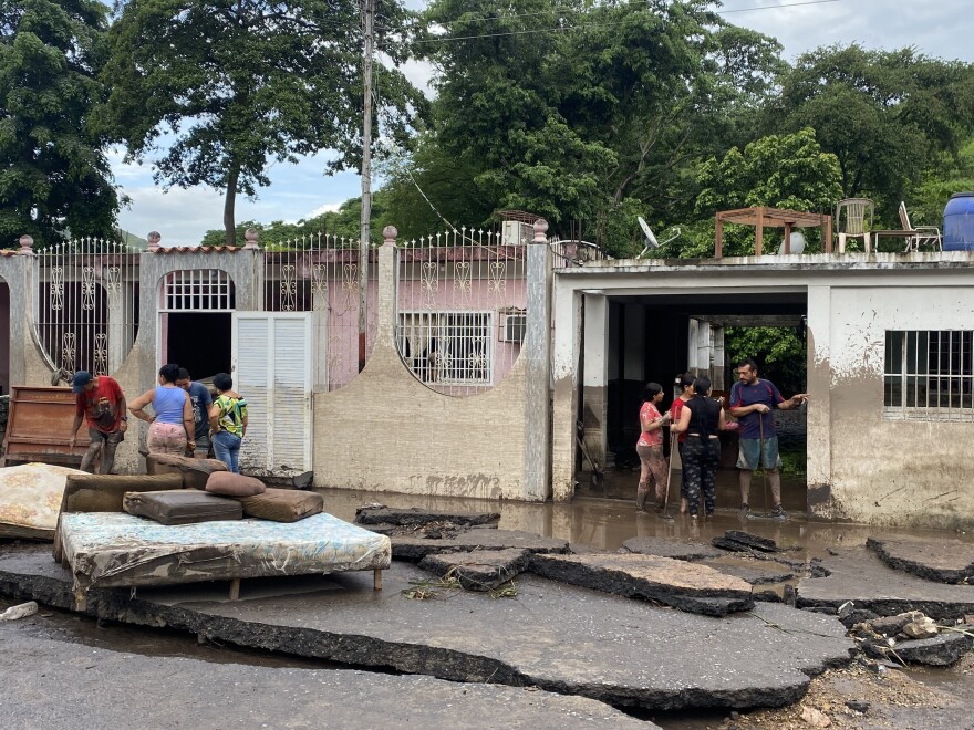 Residents try to recover their belongings from their flooded houses after a river swelled due to heavy rains following the passage of Hurricane Beryl on the road from Cumana to Cumanacoa, Sucre State, Venezuela, on July 2, 2024. Hurricane Beryl churned towards Jamaica Tuesday after killing at least five people and causing widespread destruction across the southeastern Caribbean, threatening deadly winds and storm surge as it approached. 