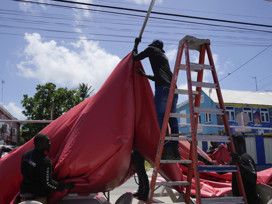 People disassemble a beach bar's awning in preparation for Hurricane Beryl, in Bridgetown, Barbados, Sunday, June 30.