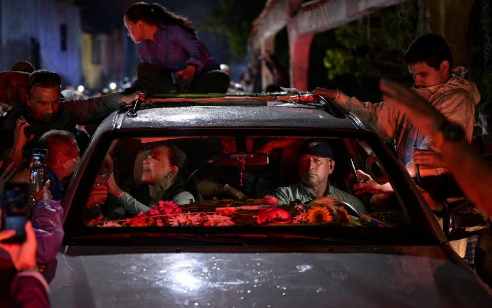 Milciades Avila at the wheel of Maria Corina Machado's car during a rally in Merida state last month