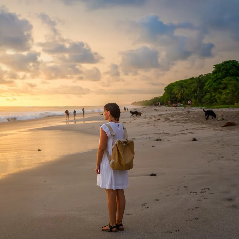 Costa Rica, young girl looking at the ocean at sunset, Playa Carmen.