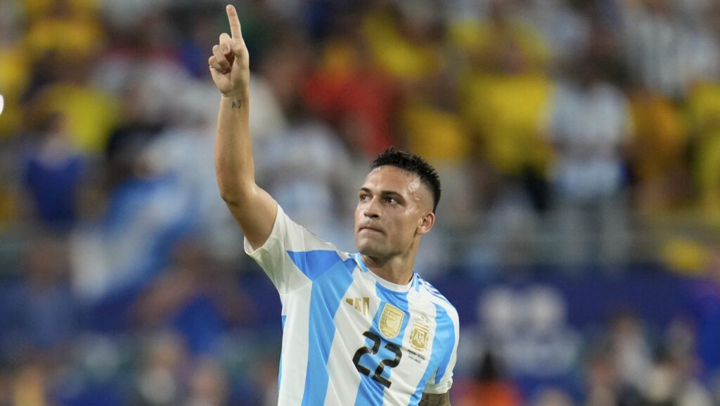 Argentina's Lautaro Martínez celebrates scoring his side's opening goal against Colombia during th...