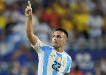 Argentina's Lautaro Martínez celebrates scoring his side's opening goal against Colombia during th...