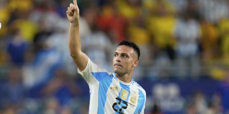 Argentina's Lautaro Martínez celebrates scoring his side's opening goal against Colombia during th...