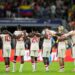 Canada players link arms before a shootout during a Copa America quarterfinal soccer match between Venezuela and Canada, Friday, July 5, 2024, in Arlington, Texas.