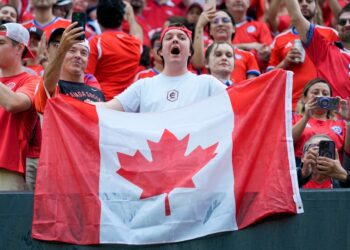 A soccer fan holds a Canadian flag prior to a Copa America Group A soccer match against Chile, in Orlando, Fla., Saturday, June 29, 2024. (John Raoux / AP Photo)