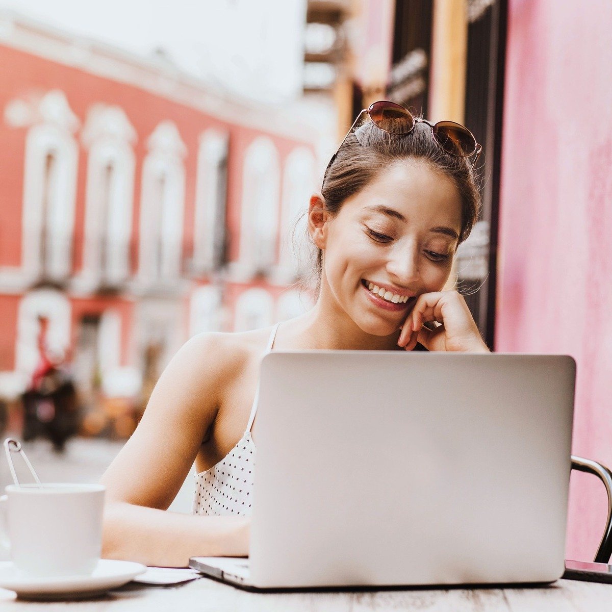 Young Woman Working Outside From A Cafe In A Colonial City In Latin America, Digital Nomad