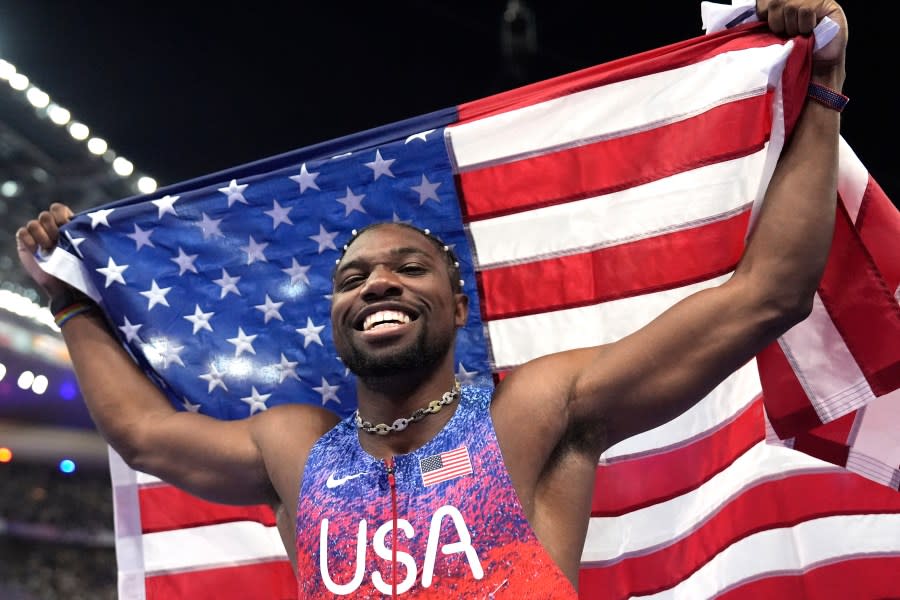 Noah Lyles, of the United States, celebrates after winning the men's 100-meters final at the 2024 Summer Olympics, Sunday, Aug. 4, 2024, in Saint-Denis, France. (AP Photo/Matthias Schrader)