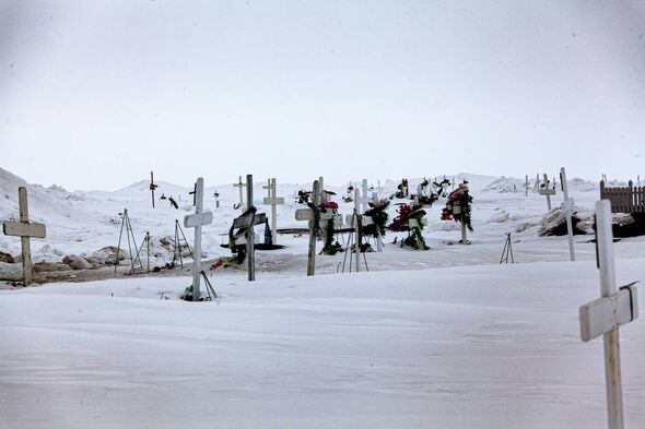 A cemetery of simple white crosses on the outskirts of the town but this time covered in snow