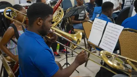 Gemma Handy Orlando Gordon during a practice session with the brass section