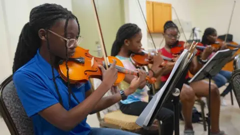 Gemma Handy Emily James playing with the string section during a practice session ahead of October's show with the Royal Philharmonic Orchestra in London