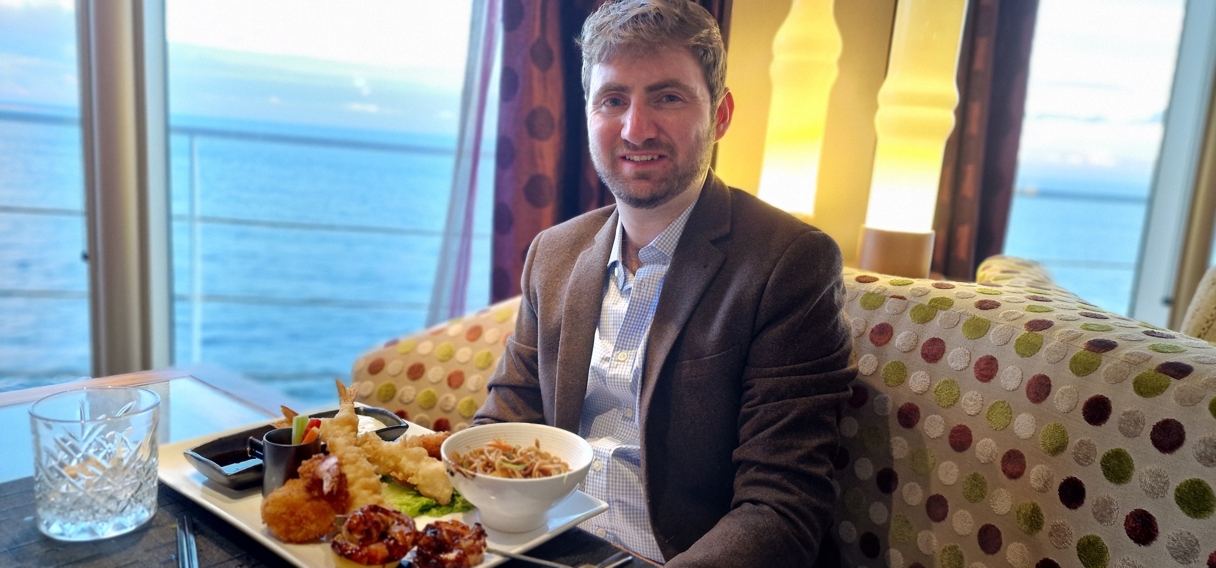 Paul dining at Marimoto by Sea with ocean views from the table