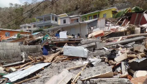Gemma Handy The body of Lucy Thomas, 74, is believed to be under this rubble in Scott's Head, Dominica