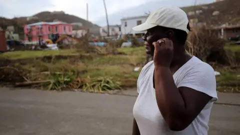 Paul Blake/BBC Local resident amid debris on British Virgin Islands