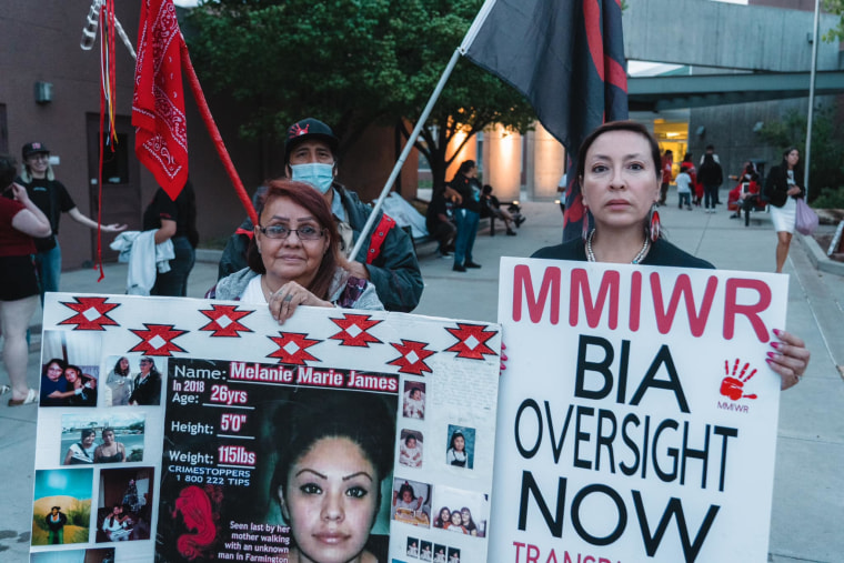 Lela Mailman and Darlene Gomez holding signs at an MMIW rally