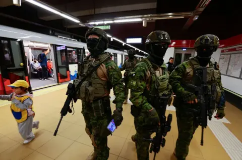 Getty Images Military officers guard a metro station on January 09, 2024 in Quito, Ecuador. President Noboa declared on Monday 8th a 60-day state of emergency and curfew