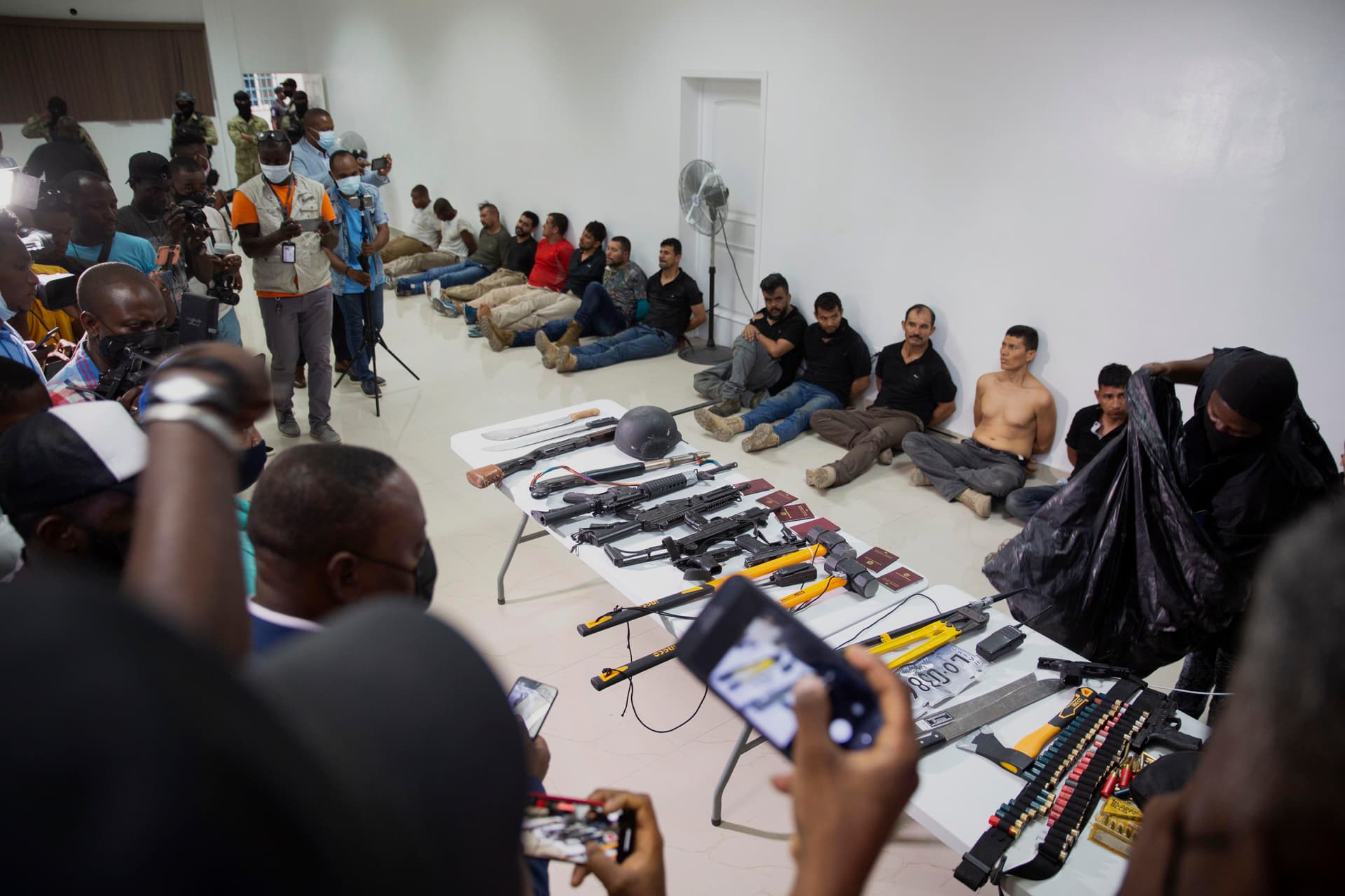 Suspects in the assassination of Haiti's President Jovenel Moise are shown to the media, along with the weapons and equipment they allegedly used in the attack, at the General Direction of the police in Port-au-Prince, Haiti, Thursday, July 8, 2021.