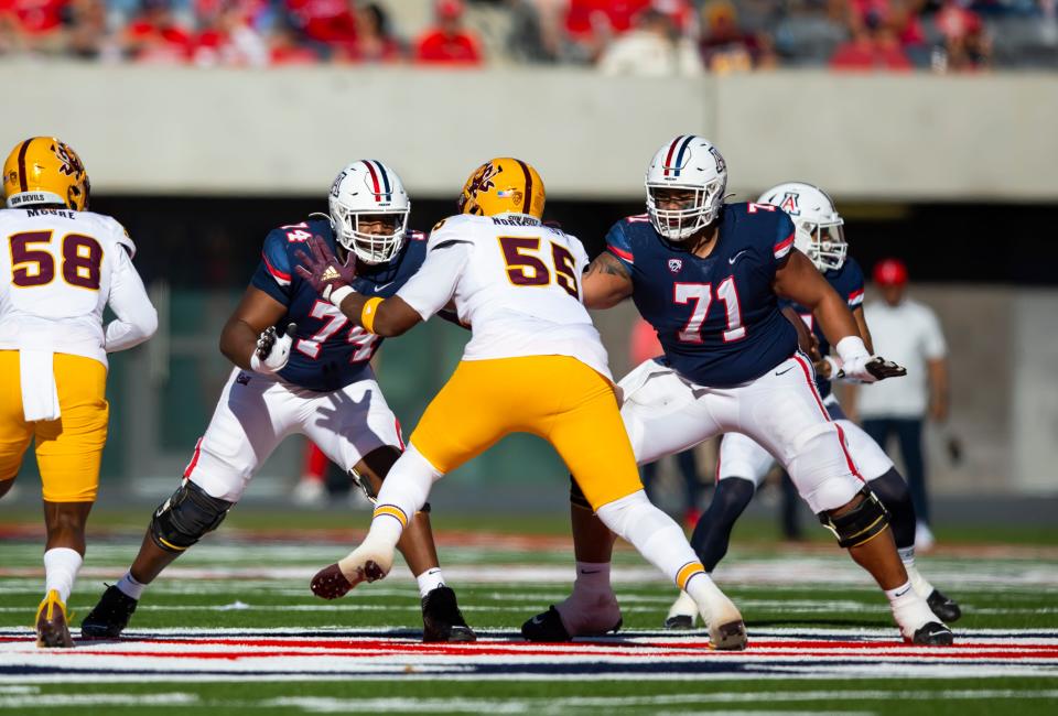 Nov 25, 2022; Tucson, Arizona, USA; Arizona Wildcats offensive lineman Paiton Fears (74) and Jonah Savaiinaea (71) against Arizona State Sun Devils defensive lineman Omarr Norman-Lott (55) during the Territorial Cup at Arizona Stadium. Mandatory Credit: Mark J. Rebilas-USA TODAY Sports