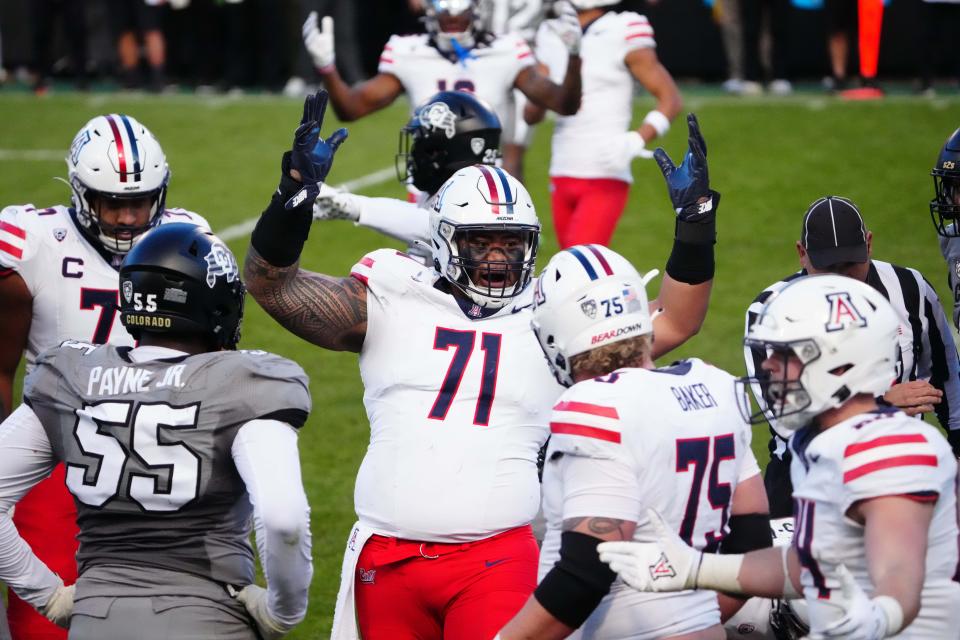 Nov 11, 2023; Boulder, Colorado, USA; Arizona Wildcats offensive lineman Jonah Savaiinaea (71) celebrates defeating the against the Colorado Buffaloes at Folsom Field. Mandatory Credit: Ron Chenoy-USA TODAY Sports