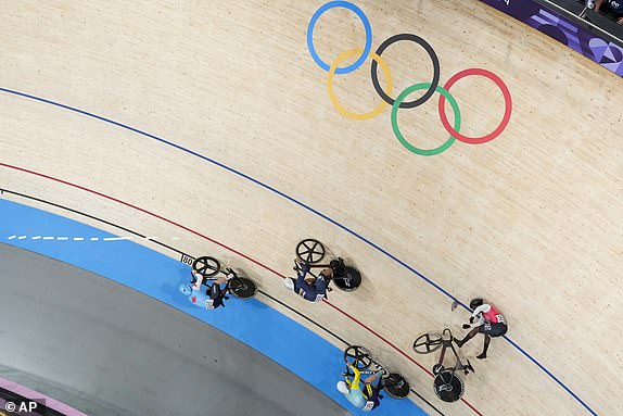 Kwesi Browne of Trinidad And Tobago, right, crashes during the men's keirin event, at the Summer Olympics, Saturday, Aug. 10, 2024, in Paris, France. (AP Photo/Thibault Camus)