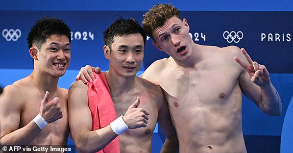 (L-R) Silver medallist Japan's Rikuto Tamai, gold medallist China's Cao Yuan and bronze medallist Britain's Noah Williams celebrate after the men's 10m platform diving final during the Paris 2024 Olympic Games at the Aquatics Centre in Saint-Denis, north of Paris, on August 10, 2024. (Photo by Manan VATSYAYANA / AFP) (Photo by MANAN VATSYAYANA/AFP via Getty Images)