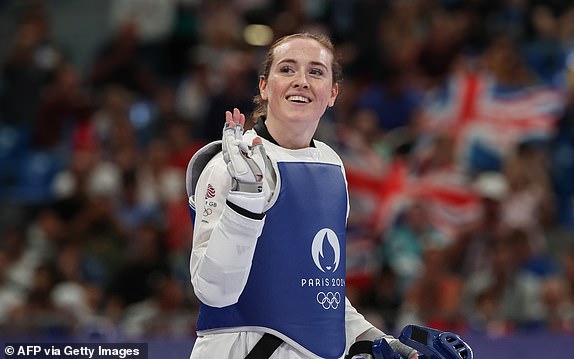 Britain's Rebecca Mcgowan celebrates after winning in the taekwondo women's +67kg round of 16 bout of the Paris 2024 Olympic Games at the Grand Palais in Paris on August 10, 2024. (Photo by David GRAY / AFP) (Photo by DAVID GRAY/AFP via Getty Images)