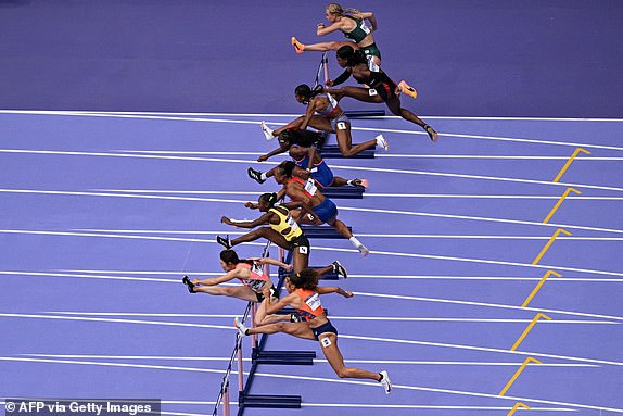 (From top) South Africa's Marione Fourie, Britain's Cindy Sember, US' Masai Russell, France's Cyrena Samba-Mayela, Puerto Rico's Jasmine Camacho-Quinn, Jamaica's Ackera Nugent, Japan's Mako Fukube and Netherlands' Maayke Tjin-A-Lim compete in the women's 100m hurdles semi-final of the athletics event at the Paris 2024 Olympic Games at Stade de France in Saint-Denis, north of Paris, on August 9, 2024. (Photo by Antonin THUILLIER / AFP) (Photo by ANTONIN THUILLIER/AFP via Getty Images)