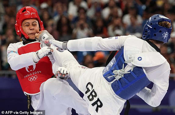 Fiji's Venice Elizabeth Megan Traill (L) competes against Britain's Rebecca Mcgowan in the taekwondo women's +67kg round of 16 bout of the Paris 2024 Olympic Games at the Grand Palais in Paris on August 10, 2024. (Photo by David GRAY / AFP) (Photo by DAVID GRAY/AFP via Getty Images)