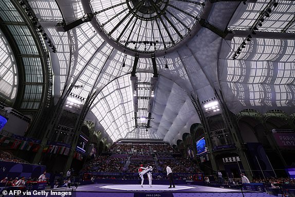 China's Song Zhaoxiang (L) competes against US' Jonathan Healy in the taekwondo men's +80kg round of 16 bout of the Paris 2024 Olympic Games at the Grand Palais in Paris on August 10, 2024. (Photo by David GRAY / AFP) (Photo by DAVID GRAY/AFP via Getty Images)