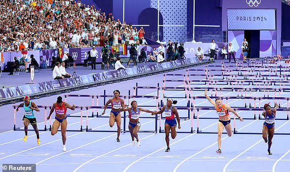 Paris 2024 Olympics - Athletics - Women's 100m Hurdles Final - Stade de France, Saint-Denis, France - August 10, 2024. Masai Russell of United States crosses the line to win gold ahead of silver medallist Cyrena Samba-Mayela of France and bronze medallist Jasmine Camacho-Quinn of Puerto Rico. REUTERS/Phil Noble