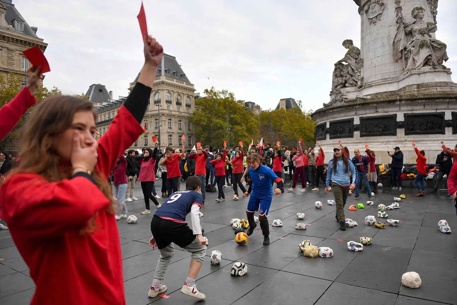 A protestor holds a red card during a demonstration against the 2022 World Cup in Qatar in Paris, on Nov. 20, 2022.