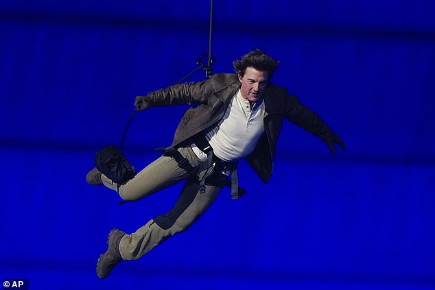 Action star Tom Cruise kicked off the Olympic handover by jumping from the roof of the Stade de France in a death-defying stunt