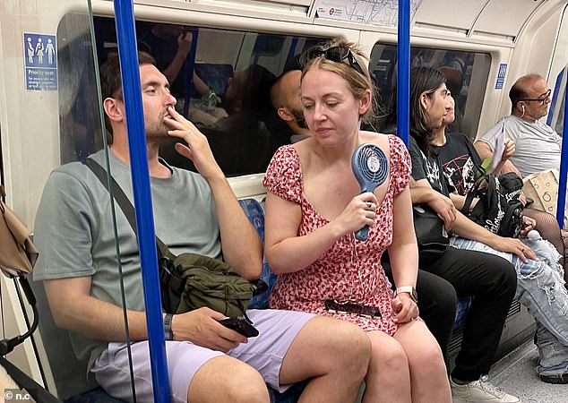 Commuters in London were not so lucky - as they were forced to cool themselves down with fans on their muggy journeys on the tube