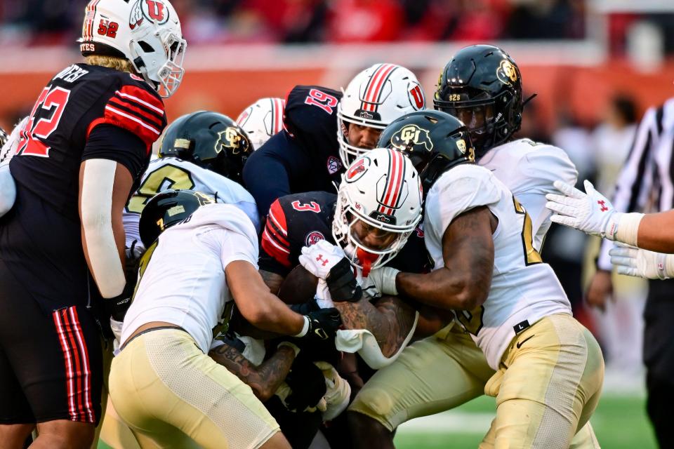 Nov 25, 2023; Salt Lake City, Utah, USA; Utah Utes running back Ja'Quinden Jackson (3) breaks through Colorado Buffaloes defense at Rice-Eccles Stadium. Mandatory Credit: Christopher Creveling-USA TODAY Sports