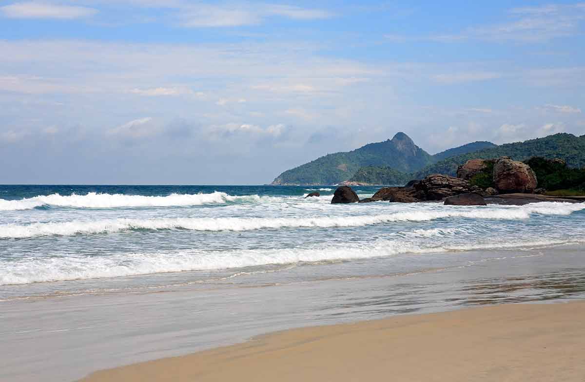 most beautiful beaches in south america beach, waves and mountain in the background