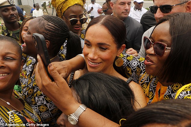 Meghan poses for a photograph in Abuja, Nigeria