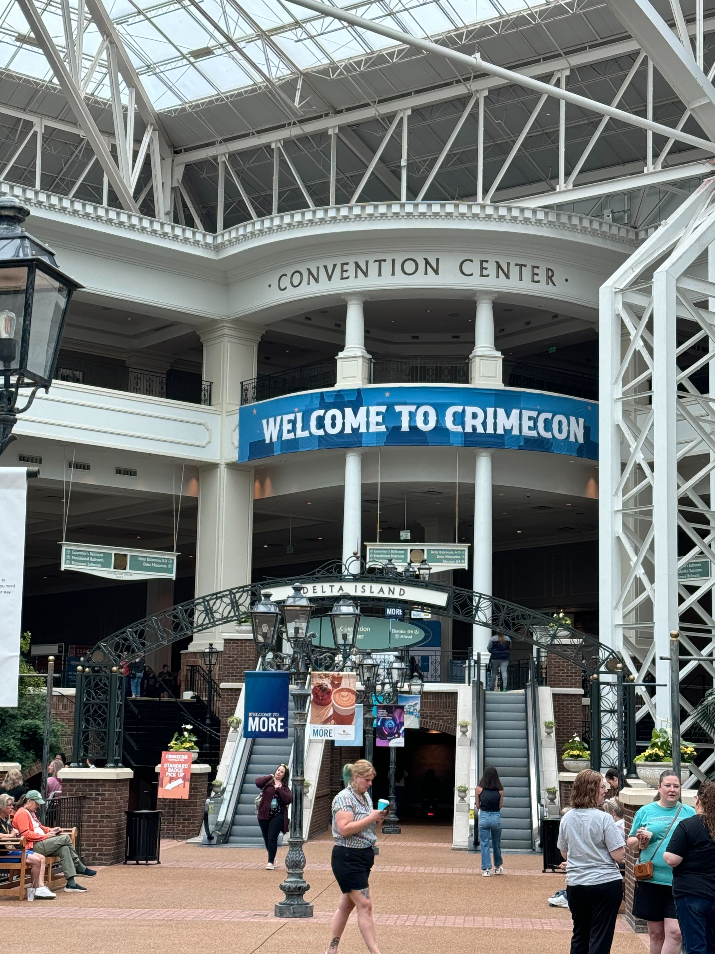 Exterior of a convention center in Gaylord Opryland, with tall white columns and a banner that says 